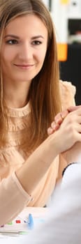 Beautiful woman and man hold hands in fight at the workplace in office. Emancipation feminism and struggle in business with colleagues