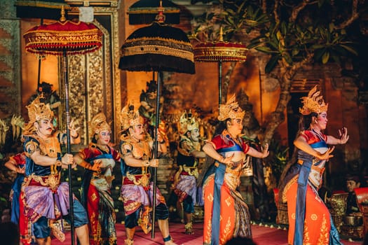 UBUD, BALI, INDONESIA - FEBRUARY 10, 2023: Traditional dance Legong and Barong in Ubud Palace is performed by local professional actors with colorful clothes, expressive gestures, facial expressions