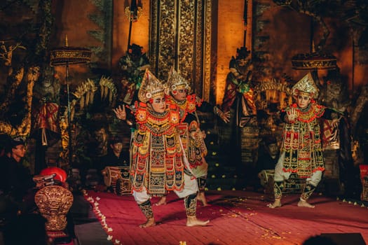 UBUD, BALI, INDONESIA - FEBRUARY 10, 2023: Traditional dance Legong and Barong in Ubud Palace, Balinese dance show with colorful dressed artists. Traditional balinese religious ritual performance