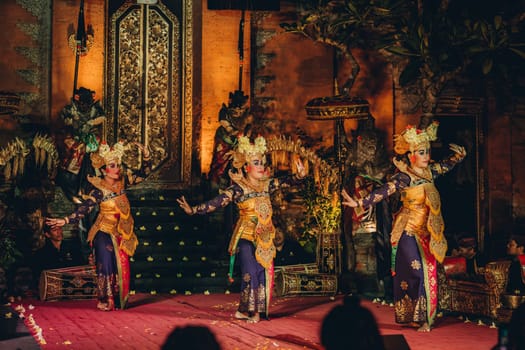 UBUD, BALI, INDONESIA - FEBRUARY 10, 2023: Traditional dance Legong and Barong in Ubud Palace is performed by local professional actors with colorful clothes, expressive gestures, facial expressions