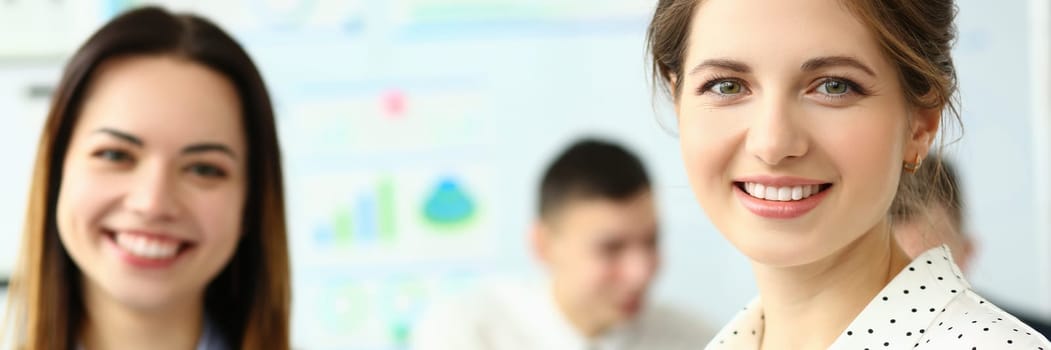 Business woman with staff and a group of people in background in modern office. Business group of people and project teamwork