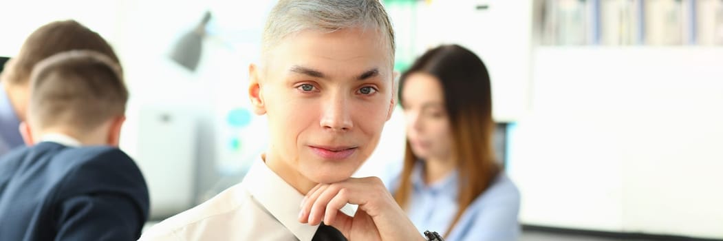 Portrait of confident young businessman in creative office conference room. Business consultant manager and businessman confident look