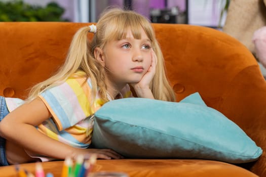 Sad lonely toddler girl at home looks pensive thinks over life concerns or study test exam fail, suffers from unfair situation. Teen child, kid problem, break up, depressed feeling bad annoyed burnout