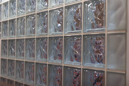 Thick glass block wall background at the expo. Mid shot