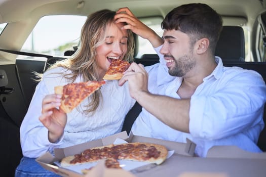Pizza, love couple eating on a road trip on holiday vacation or romantic lunch date to in a car or vehicle. Travel, fast food or woman bonding enjoying a fun memory a happy partner in summer romance.