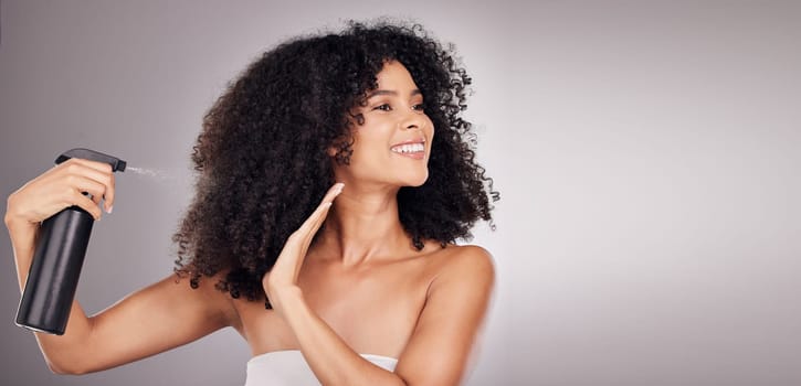 Hair, spray and black woman with product for natural wellness, growth and shine on gray background. Beauty face, salon copy space and happy girl smile with hairspray, cosmetics and keratin treatment.