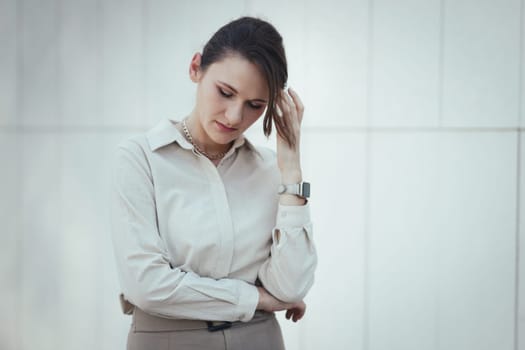 Caucasian woman in office or business style in clothes feels tired and depressed, burnout at work.