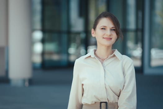 Happy smiling portrait of caucasian female company leader CEO boss executive standing in front of office building.