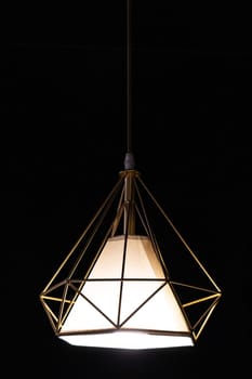 Close-up of modern garden pendant lamp hanging outdoor terrace during in the dark, vertical.