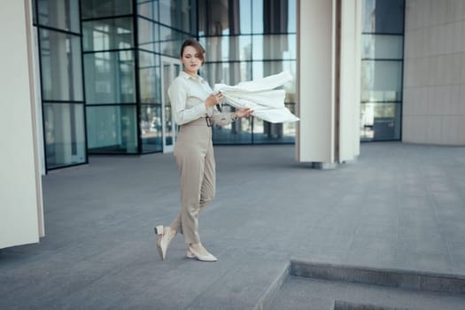 Beautiful blonde woman with natural make-up wears a trendy business pantsuit near the business center.