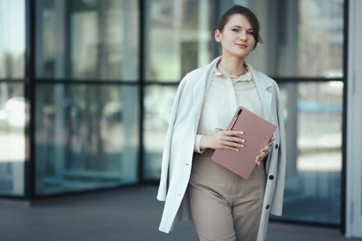 Portrait of a caucasian successful business woman with digital tablet.