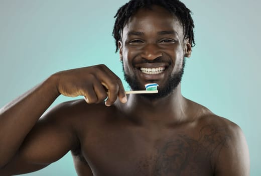 Black man, face and toothbrush with smile in portrait, teeth whitening and cleaning mouth isolated on studio background. Fresh breath, beauty and hygiene with toothpaste, health and dental wellness.