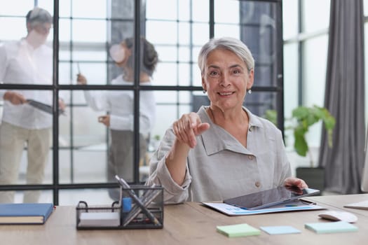 Modern mature businesswoman working at her desk