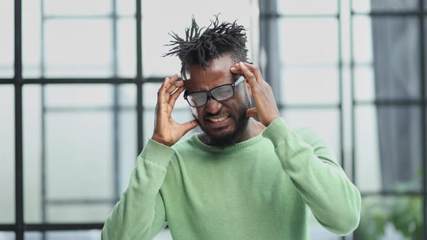 Portrait of sad unhappy African man having bad headache