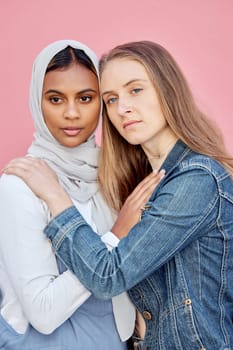 LGBTQ, love and lesbian couple with embrace of sexuality isolated on a pink background. Freedom, hug and diversity in a relationship with women hugging for affection, romance and a date on a backdrop.