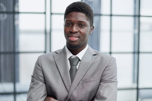 Smiling millennial confident black guy posing for photo, looking at camera