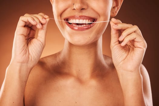 Teeth, zoom and woman with floss for dental cleaning, teeth whitening and healthy mouth protection in studio. Smile, wellness or hands of girl flossing with thread for natural tooth shine, self care.