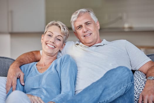 Senior couple, sofa and portrait with smile, love and happy in retirement, bonding or care in family house. Old woman, elderly man and hug on couch for happiness, romance or embrace together at house.