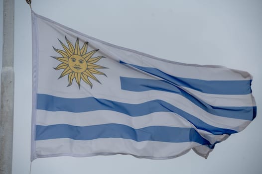 Uruguayan flag on the Colonia Express ship in the port of Buenos Aires on a rainy day.
