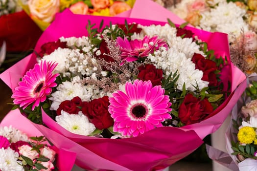 Mixed colorful flowers background. Vibrant colors of mixed flowers backdrop. gerbera, tulips and mix of summer flowers bouquet