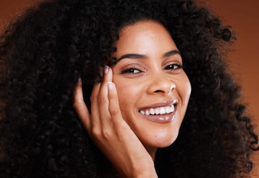 Hair care, beauty and black woman with natural makeup, cosmetics and skincare in studio for wellness, healthy glow and face promotion. Cosmetic, self love and young model with a facial shine portrait.