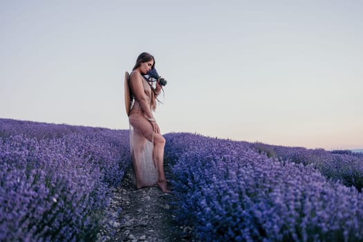 Close up portrait of young beautiful woman in a white dress and a hat is walking in the lavender field and smelling lavender bouquet.