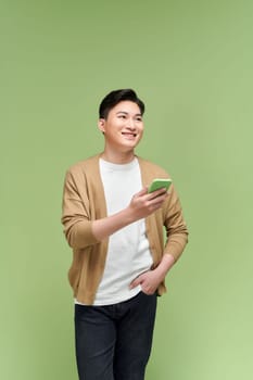 Asian handsome young and cheerful man with smart phone on hand,