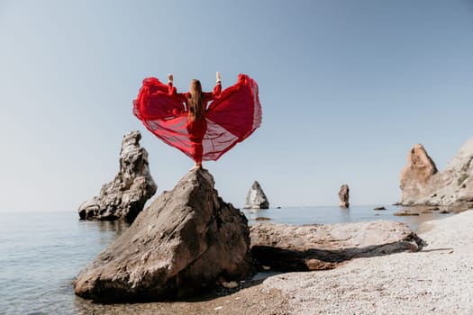 Woman travel sea. Happy tourist taking picture outdoors for memories. Woman traveler looks at the edge of the cliff on the sea bay of mountains, sharing travel adventure journey.