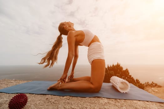 Woman sea pilates. Sporty, middle-aged woman practicing pilates in park near the sea. trains on a yoga mat and exudes a happy and active demeanor, promoting the idea of a healthy lifestyle through exercise and meditation.