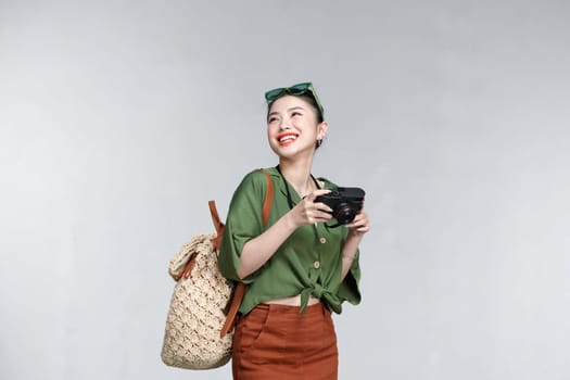 happy elegant woman isolated on white background with backpack and photo camera.