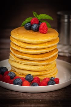 Recipe for maple syrup pancakes with raspberry and blueberry filling, High quality photo