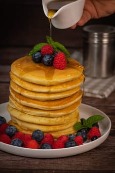 Recipe for maple syrup pancakes with raspberry and blueberry filling, High quality photo