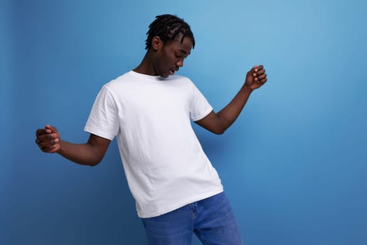 charming african young adult with dreadlocks in white t-shirt with blank space for logo.