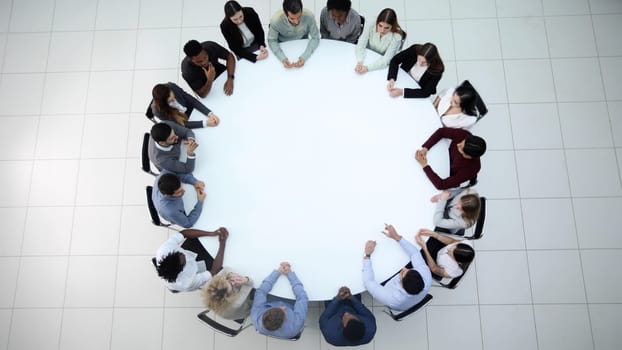 Round table top view. Business people sitting meeting corporate workspace brainstorming working team