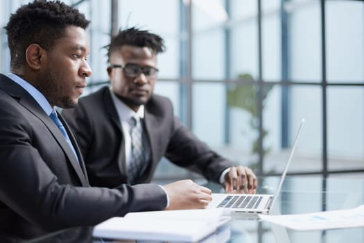 African american boss negotiating discussing contract details with company corporate client.