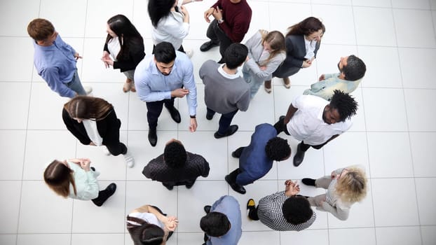 Young people in the conference room communicate top view