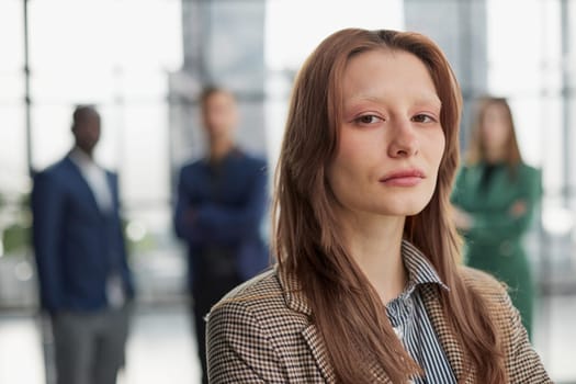 Portrait of a confident young businesswoman standing with her arms crossed in an office