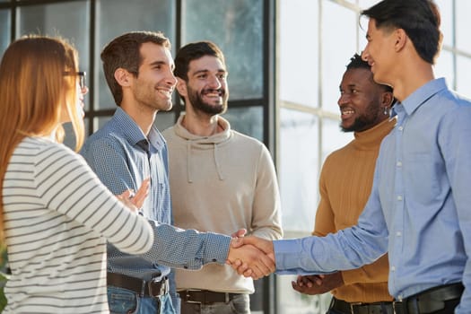 friendly hr manager or team leader greeting or welcoming new worker