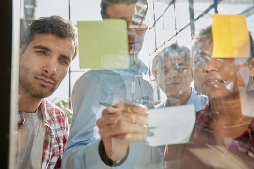 Group of business people behind glass wall at office