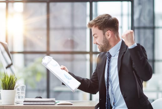 energetic businessman celebrating in office