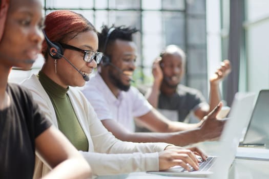 Call Center Operator With Colleagues At Workplace