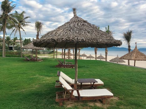 sky,nature,shade,botany,tree,outdoor,furniture,cloud,plant,thatching,arecales,gazebo,grass,leisure,pavilion,resort,sunlounger,table,umbrella,vacation