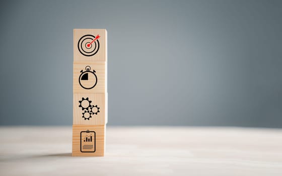 Action Plan, Goal, and Target icons on a wooden block step. Success and business target concept. Company strategy and project management symbolize progress.