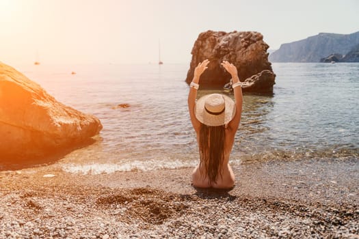 Woman travel sea. Happy tourist taking picture outdoors for memories. Woman traveler looks at the edge of the cliff on the sea bay of mountains, sharing travel adventure journey.