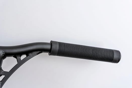 the handle bar of a stunt scooter with black rubber comfortable grips, a stunt scooter, equipment for extreme skating in a skatepark and on a ramp. Details of the scooter. Repair, rental and sale of scooters