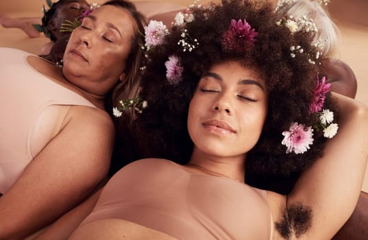 Flowers, sleep and face of women in studio relaxing for peace, beauty or zen. Floral makeup, organic cosmetics and diversity of body positive group of friends in underwear sleeping together on floor