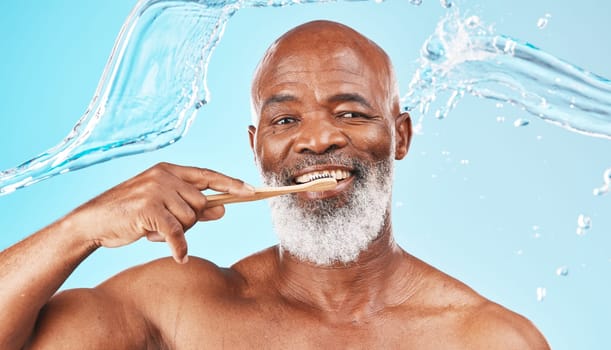 Black man, dental hygiene and toothbrush with water, wellness and hygiene against blue studio background. Oral health, African American male and mature guy with smile, toothpaste and clean mouth