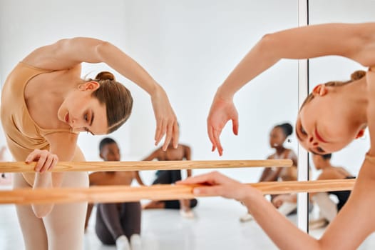 Ballet, mirror and woman stretching for dance, fitness or theater rehearsal at studio, flexible and artistic. Creative, stretch and girl ballerina with stage,performance and beauty or art preparation.