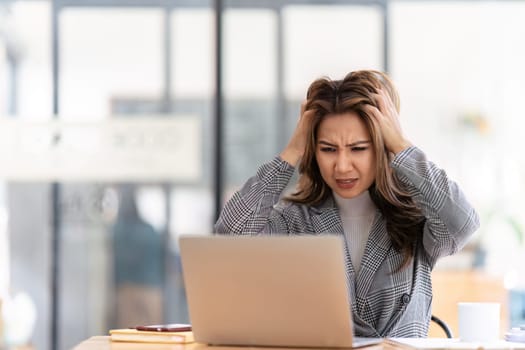 Woman working at with headache, burnout and stress over social media marketing or company deadline. Anxiety, exhausted and tired web or online business advertising expert with migraine.