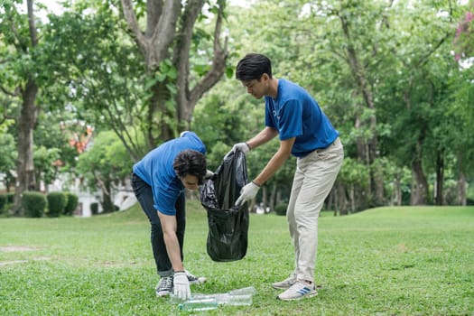 volunteering, charity, cleaning, young and ecology concept group of happy volunteers with garbage bags cleaning area.